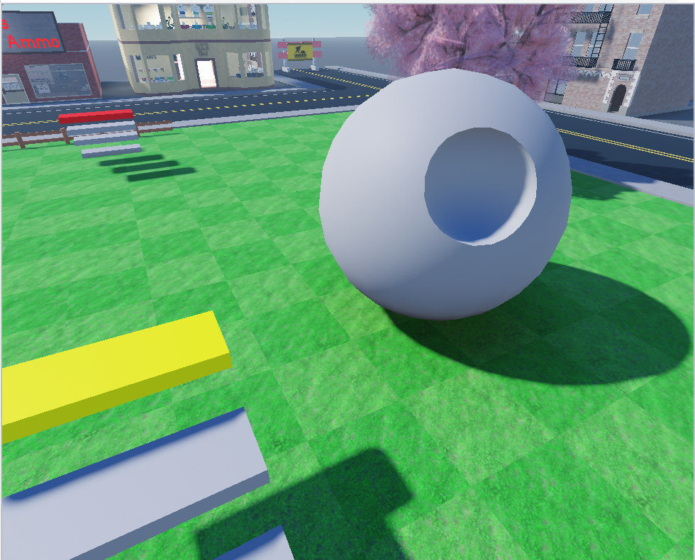Roblox Studioの画面。草原の上に、まん中に丸い穴があいた大きな球が置かれている